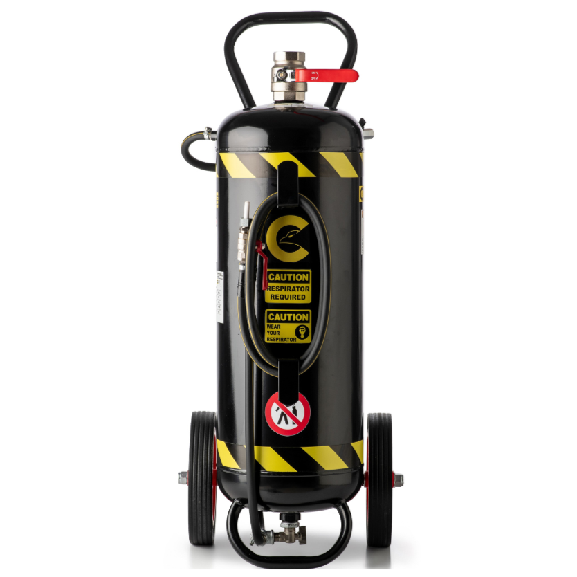 A portable Coanda Sandblaster 55 Lt Basic with a black tank, mounted on wheels, with yellow hoses and red safety labels. This professional Coanda Sandblaster is made to sandblast wood, rust, metals etc.