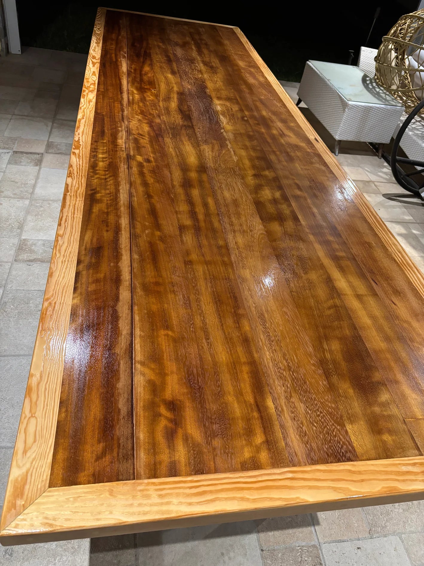 Wooden dining table with a polished finish after sandblasting.